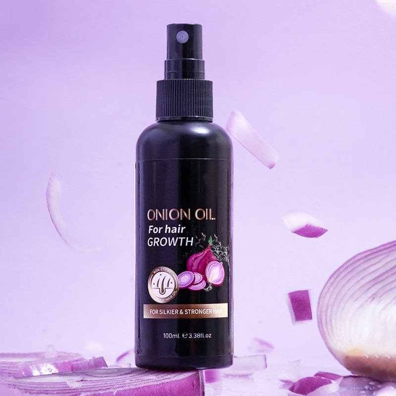 100ml Onion Hair Care Oil for All Hair Types with moisturizing benefits, shown in a sleek black spray bottle surrounded by fresh onion slices.